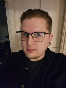 jason pic A man with glasses and a black shirt