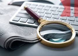 images-1 A magnifying glass sitting on top of a keyboard.
